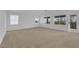 Large bedroom with neutral carpet, bright natural light from the large windows and patio access at 2033 Old Field Ave, North Las Vegas, NV 89081