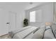 Cozy bedroom with natural light, complemented by ample closet space, and plant accents at 2033 Old Field Ave, North Las Vegas, NV 89081