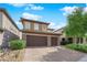 This house features a three-car garage, tile roof, manicured lawn and desert landscaping at 2033 Old Field Ave, North Las Vegas, NV 89081