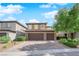 This attractive two-story house features a three-car garage and tasteful landscaping at 2033 Old Field Ave, North Las Vegas, NV 89081