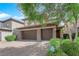 A two-story home features an attached three-car garage and a tile roof at 2033 Old Field Ave, North Las Vegas, NV 89081