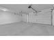 Spacious two car garage featuring two garage doors, and neutral paint at 2033 Old Field Ave, North Las Vegas, NV 89081