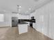 Bright kitchen featuring stainless steel appliances, black countertops, and white cabinets at 2033 Old Field Ave, North Las Vegas, NV 89081