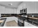 Bright kitchen featuring stainless steel appliances, and black countertops at 2033 Old Field Ave, North Las Vegas, NV 89081