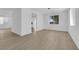 Bright open living area with hardwood flooring, white walls, and natural light at 2033 Old Field Ave, North Las Vegas, NV 89081