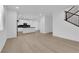 Open-concept floor plan with wood floors flowing into the bright kitchen at 2033 Old Field Ave, North Las Vegas, NV 89081