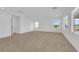 Bright, expansive living room featuring neutral carpet, large windows, and ample natural light at 2033 Old Field Ave, North Las Vegas, NV 89081
