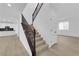 Staircase with carpet, wood railing, and an open floorplan at 2033 Old Field Ave, North Las Vegas, NV 89081
