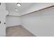 Unfurnished walk-in closet with neutral carpet and wooden shelves, ready to be organized at 2033 Old Field Ave, North Las Vegas, NV 89081