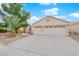 Two-car garage and front yard with desert landscaping at 2107 Akamine Ave, North Las Vegas, NV 89031