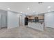 Open concept kitchen featuring dark appliances, wooden cabinets, and a breakfast bar at 2347 Via Barranca St, Henderson, NV 89044