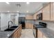 Modern kitchen with stainless steel appliances and light wood cabinets at 2347 Via Barranca St, Henderson, NV 89044