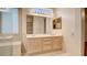 Double vanity bathroom with light wood cabinets and mirrors at 2771 Fort Myer Ave, Henderson, NV 89052