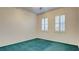 Bedroom with teal carpet and plantation shutters at 2771 Fort Myer Ave, Henderson, NV 89052