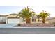 Single-story house with desert landscaping and two palm trees at 2771 Fort Myer Ave, Henderson, NV 89052