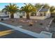 Single-story house with desert landscaping and two palm trees at 2771 Fort Myer Ave, Henderson, NV 89052
