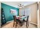 Small dining area with teal accent wall and four chairs at 2855 Geary Pl # 3205, Las Vegas, NV 89109