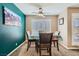 Bright dining area with a teal accent wall and four chairs at 2855 Geary Pl # 3205, Las Vegas, NV 89109