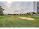 View of a lush green golf course with sand trap and distant hotel at 2855 Geary Pl # 3205, Las Vegas, NV 89109