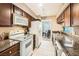 Galley kitchen with granite countertops and white appliances at 2855 Geary Pl # 3205, Las Vegas, NV 89109