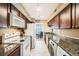 Galley-style kitchen with granite countertops and white appliances at 2855 Geary Pl # 3205, Las Vegas, NV 89109