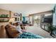 Living room with leather sofas, sliding glass doors, and golf course view at 2855 Geary Pl # 3205, Las Vegas, NV 89109