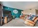 Spacious living room with leather furniture and large TV at 2855 Geary Pl # 3205, Las Vegas, NV 89109