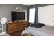 Bedroom with dresser and large TV at 3150 Soft Breezes Dr # 2025, Las Vegas, NV 89128