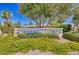 Desert Shores community entrance, landscaped with flowering plants and trees at 3150 Soft Breezes Dr # 2025, Las Vegas, NV 89128
