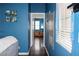 Bright hallway with hardwood floors and blue walls at 3150 Soft Breezes Dr # 2025, Las Vegas, NV 89128
