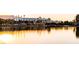 Calm lakefront view of Desert Shores community center at sunset at 3150 Soft Breezes Dr # 2025, Las Vegas, NV 89128