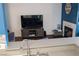 Living room with fireplace and large TV at 3150 Soft Breezes Dr # 2025, Las Vegas, NV 89128