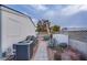 Backyard pathway with landscaping and AC unit at 3209 Tularosa Ln, Las Vegas, NV 89122