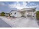 Single-wide manufactured home with carport and landscaped front yard at 3209 Tularosa Ln, Las Vegas, NV 89122