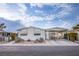 Single-wide manufactured home with carport and landscaped yard at 3209 Tularosa Ln, Las Vegas, NV 89122