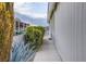 Side of house with walkway, shrubs, and a fence at 3209 Tularosa Ln, Las Vegas, NV 89122