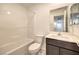 Bathroom with a vanity, toilet, and shower/tub combo with white tile surround at 374 Yellow Finch Ln, Henderson, NV 89012