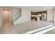 Bright and airy living room with tile floors leading into a modern kitchen with stainless steel appliances at 374 Yellow Finch Ln, Henderson, NV 89012