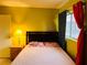 Spacious bedroom with double bed and yellow walls at 4130 Balboa Ave, Las Vegas, NV 89121
