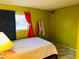 Cozy bedroom with a double bed and yellow walls at 4130 Balboa Ave, Las Vegas, NV 89121