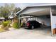 Home featuring a carport, well-maintained landscaping and a parked black car at 4130 Balboa Ave, Las Vegas, NV 89121