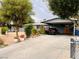 Home featuring a covered carport and a long driveway lined with plants and landscaping at 4130 Balboa Ave, Las Vegas, NV 89121
