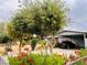 Charming home with lush landscaping, mature trees, and a black car in the driveway at 4130 Balboa Ave, Las Vegas, NV 89121