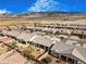 Aerial view of a quiet neighborhood featuring desert landscaping, covered patios and mountain views at 4331 Via Gallo Ct # 1, Pahrump, NV 89061
