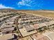 Wide aerial perspective of a desert community showcasing lush landscaping and a serene mountain range at 4331 Via Gallo Ct # 1, Pahrump, NV 89061