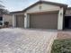 Home exterior boasts a three-car garage and a cobblestone driveway at 4331 Via Gallo Ct # 1, Pahrump, NV 89061