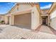 Exterior shot of a home featuring a two-car garage, stone accents, and a paved driveway at 4331 Via Gallo Ct # 1, Pahrump, NV 89061