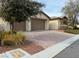 Front exterior of home with brick paved driveway and rock landscaping at 4331 Via Gallo Ct # 1, Pahrump, NV 89061