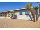 Side view of ranch home showcasing orange door and palm trees at 4506 Alpine Pl, Las Vegas, NV 89107