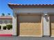 Tan double-car garage door at 50 Aura De Blanco St # 10101, Henderson, NV 89074